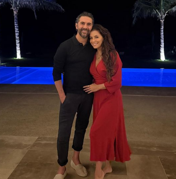 In an additional post, the actor swapped out her bikini for a gorgeous red wrap dress, posing poolside with her gorgeous husband.