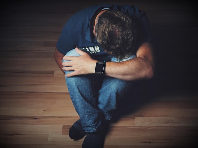 man experiencing worst pain on the floor