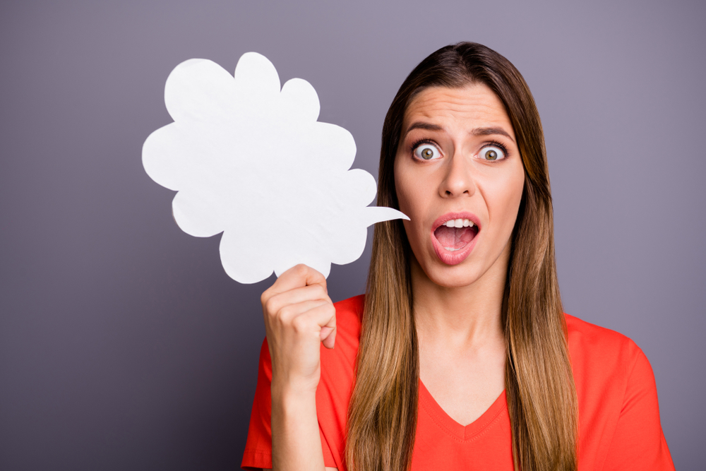 Photo of pretty funny lady holding paper mind cloud afraid of people need to say news can't find words wear casual orange t-shirt isolated grey color background
