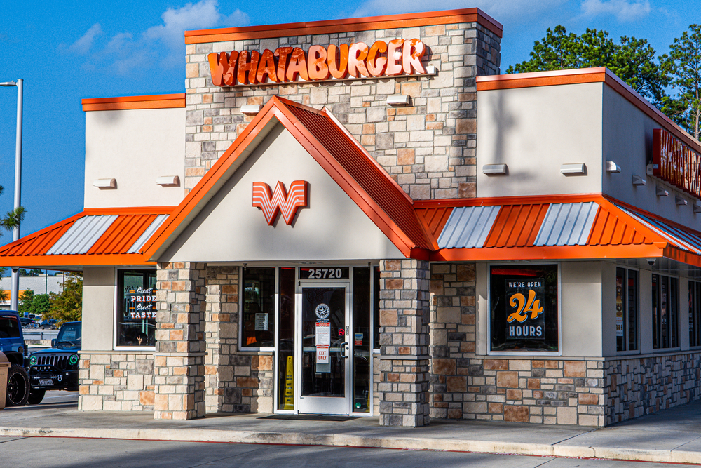 Spring, Texas / USA - July 1st, 2020: Whataburger is open and serving customers during coronavirus, store front eye level from parking lot.
