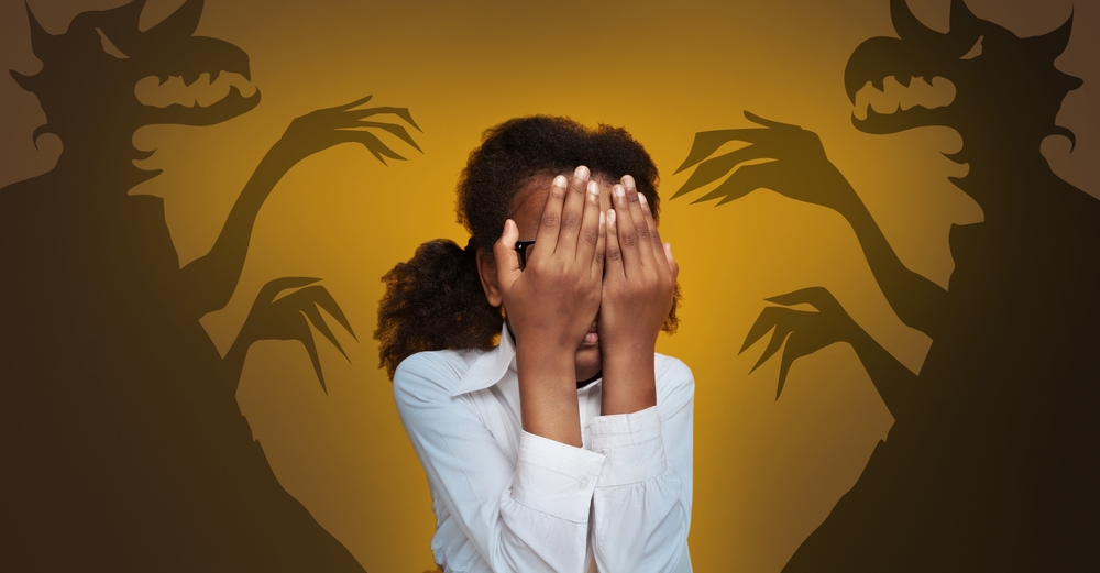 Phobias And Inner Fears Concept. Little Black Girl Afraiding Of Shadow Monsters Drawn Around Her Over Yellow Background, Terrified African American Teen Covering Face With Hands, Creative Collage
