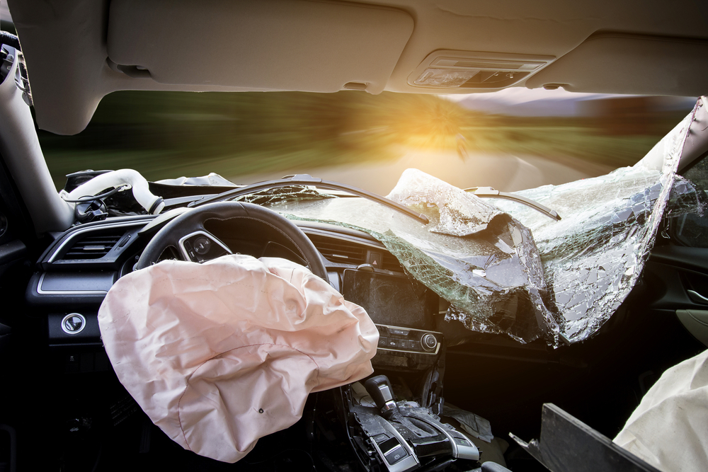 Car of accident make airbag explosion damaged at claim the insurance company. Double exposure car accident and road with mountains. Image blur focus and Adjustment beautiful color sepia style.
