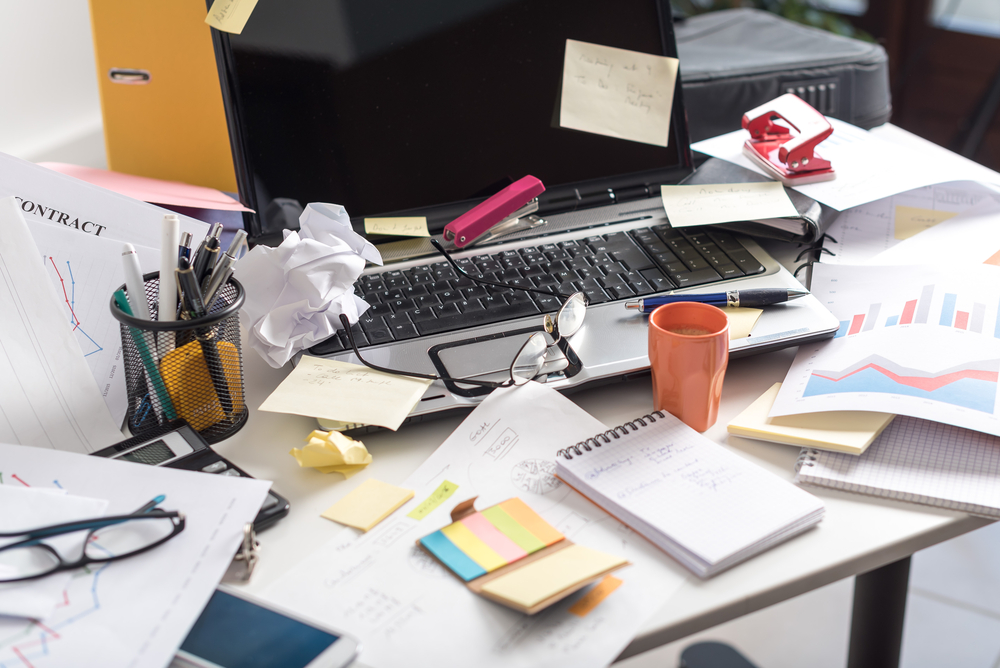 Messy and cluttered office desk