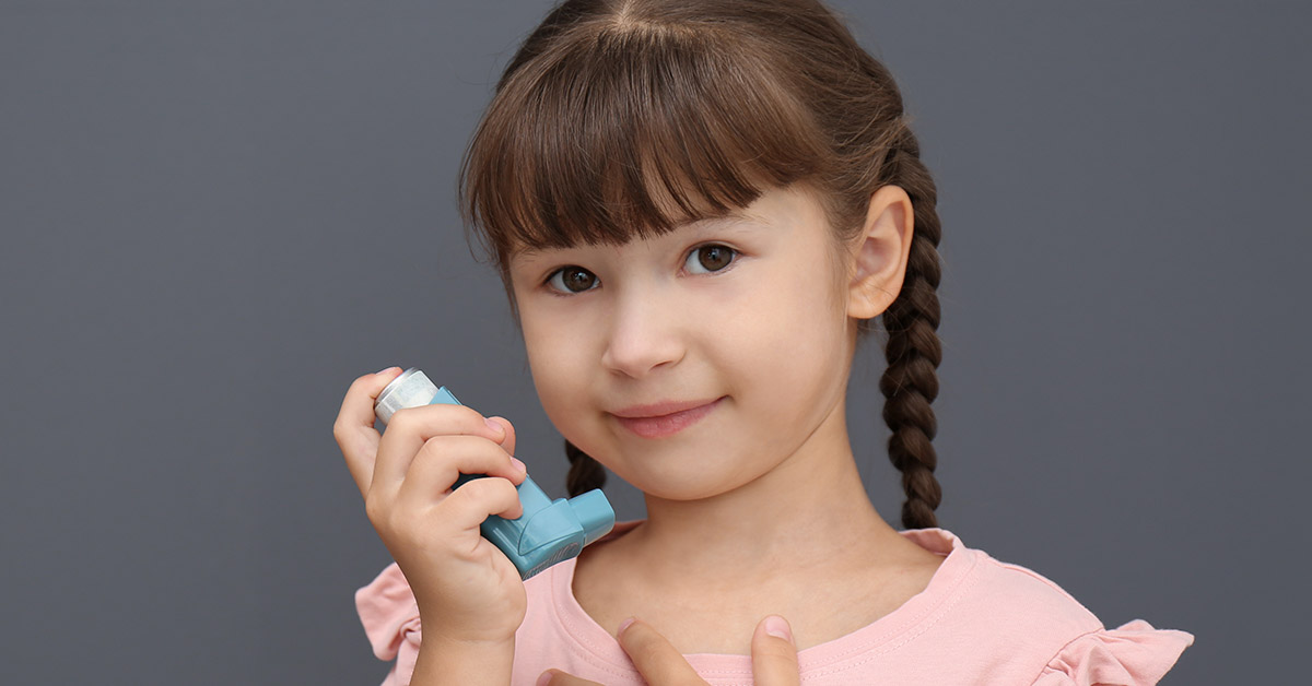 young girl with asthma inhaler