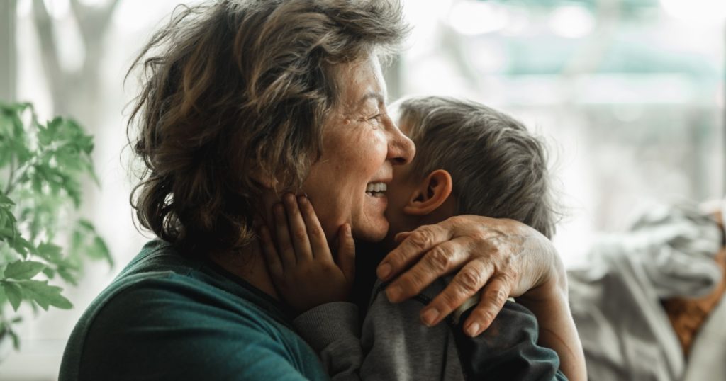 older woman hugging child