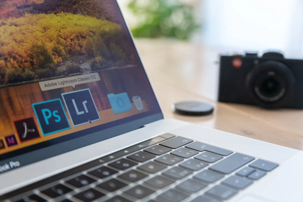 Selective Focus Photography of Macbook Pro Near Film Camera