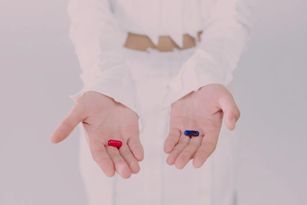 Woman holding up two pills