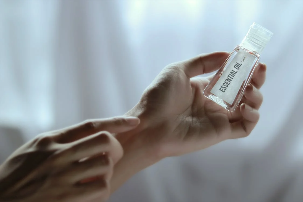 Person Holding Plastic Bottle filled with essential oil
