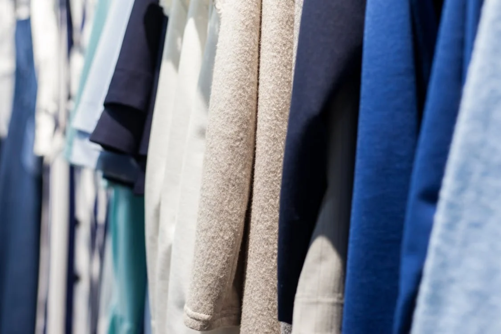 Row of assorted soft clothes in boutique