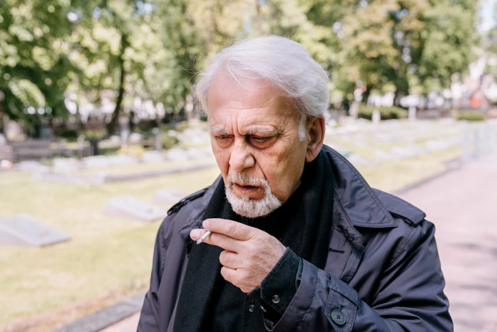 Man in Black Leather Jacket Smoking Cigarette