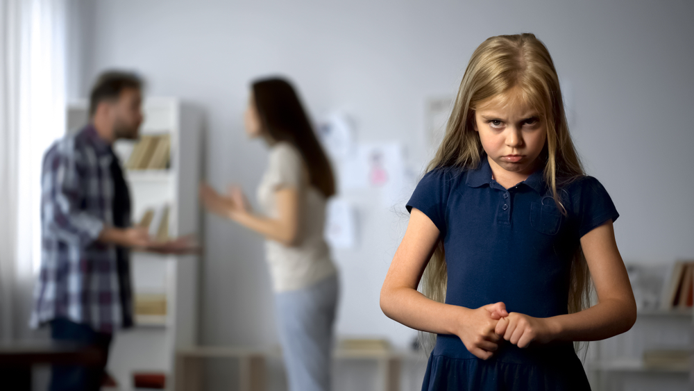 Scared schoolgirl unhappy to see parents quarrel, feeling nervous and helpless