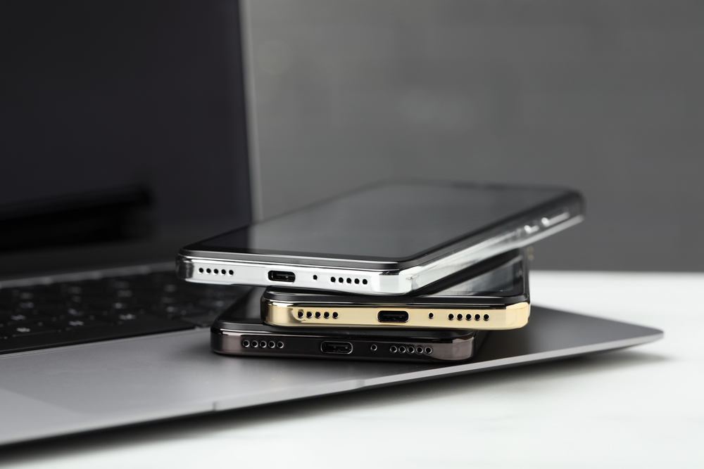 Stack of electronic devices on white table
