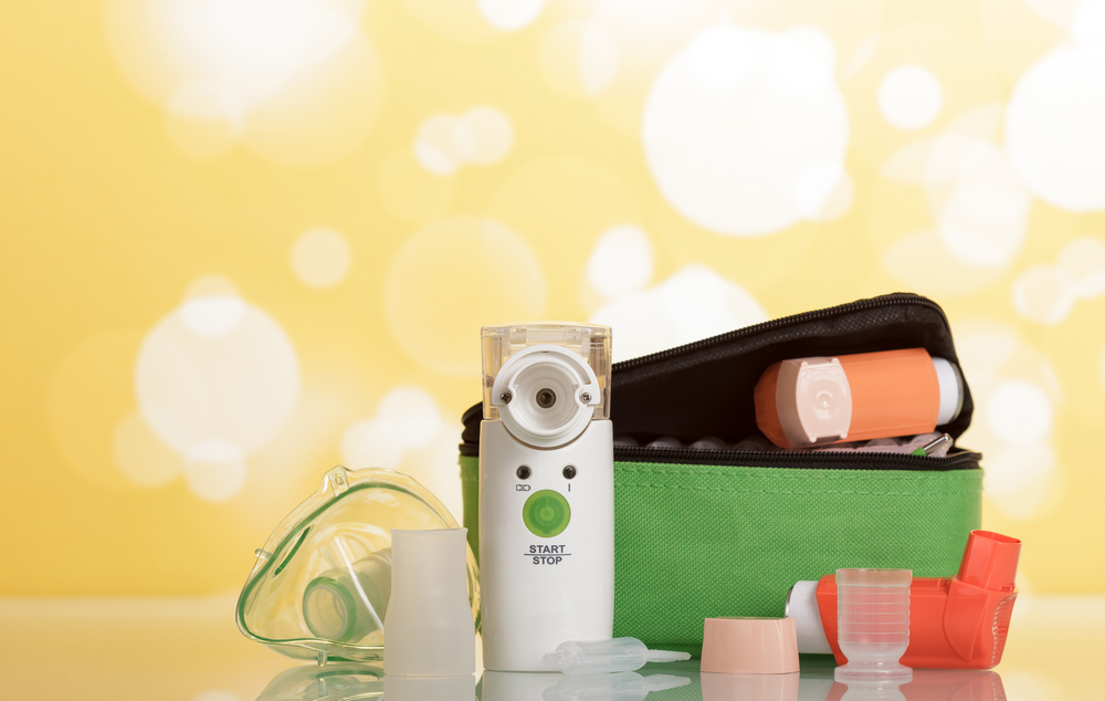 Two portable inhaler with dispenser and membrane nebulizer, on bright yellow background