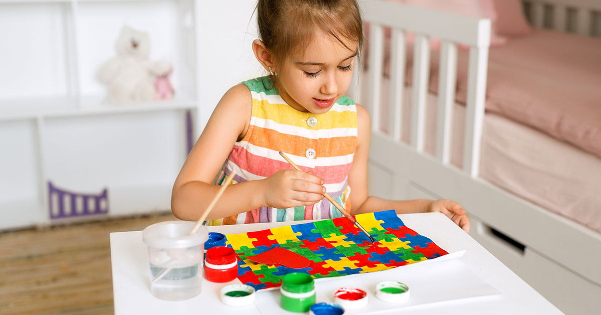 child doing a puzzle at a table