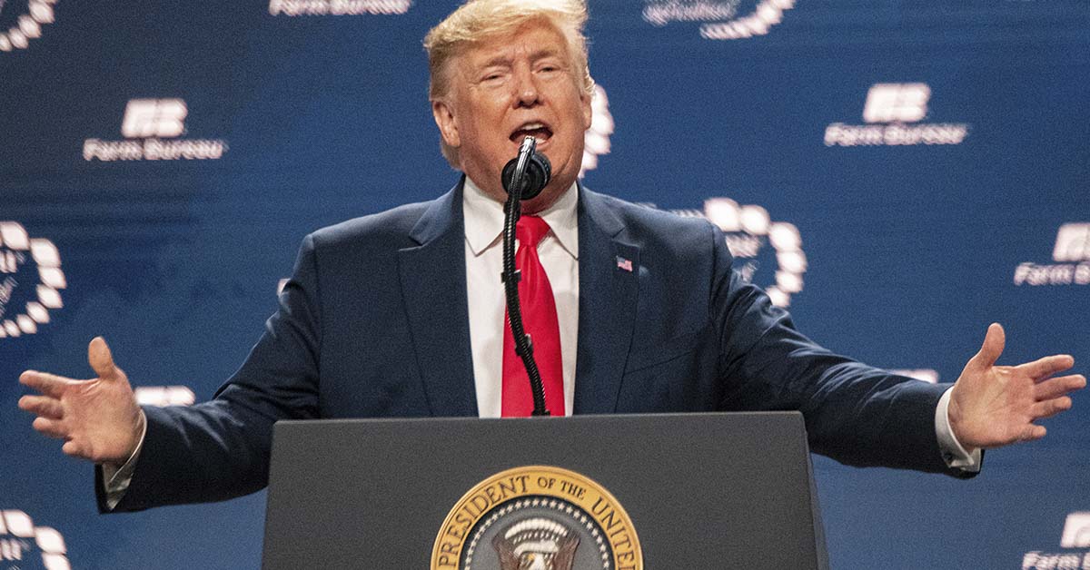Donald Trump speaking at a podium