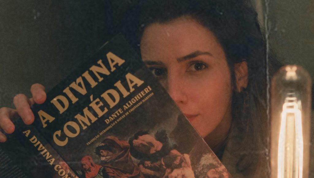 An Old Photo of a Woman Holding the Divine Comedy Book