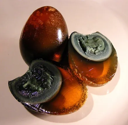 Century eggs are preserved eggs with a distinctive black color and a creamy yolk