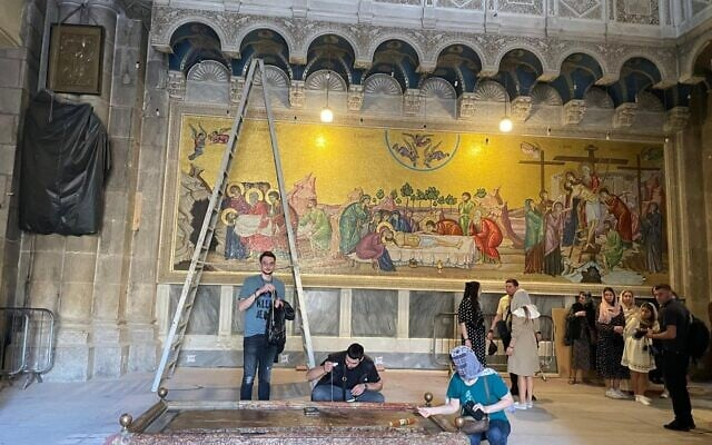 Visitors tour the Church of the Holy Sepulchre, as workers hurry to get the basilica ready for Easter