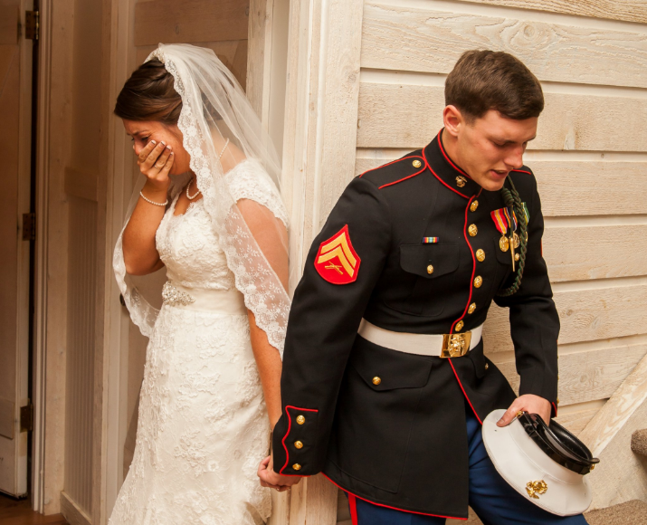 U.S. Marine Cpl. Caleb Earwood prays with his bride-to-be Maggie before their wedding service on Saturday in Asheville, North Carolina.