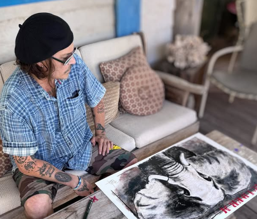 Johnny Depp with one of his art pieces