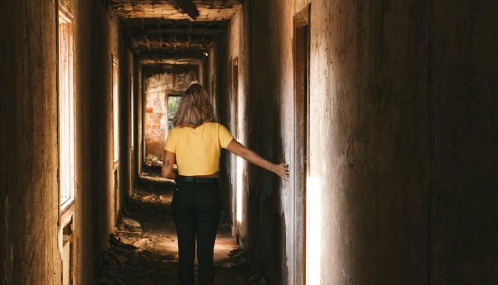woman walking down hallway in intense movie