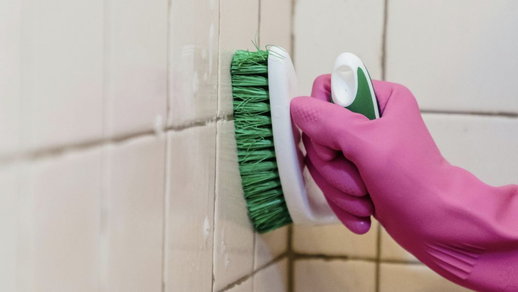 Grout being scrubbed and brush