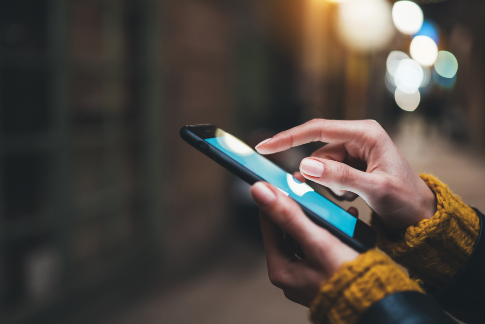 point finger on screen mobile phone closeup, person texting text message, hipster touch blue screen on smartphone light night city, girls using in hands cellphone close up, online internet