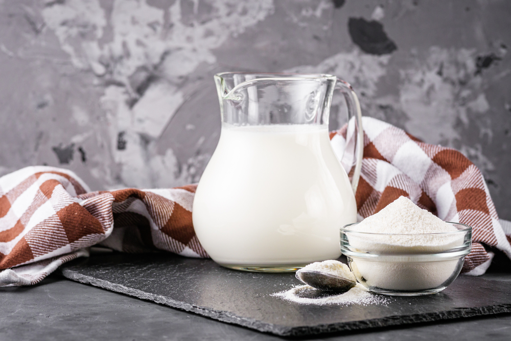 granulated milk powder on a dark stone background