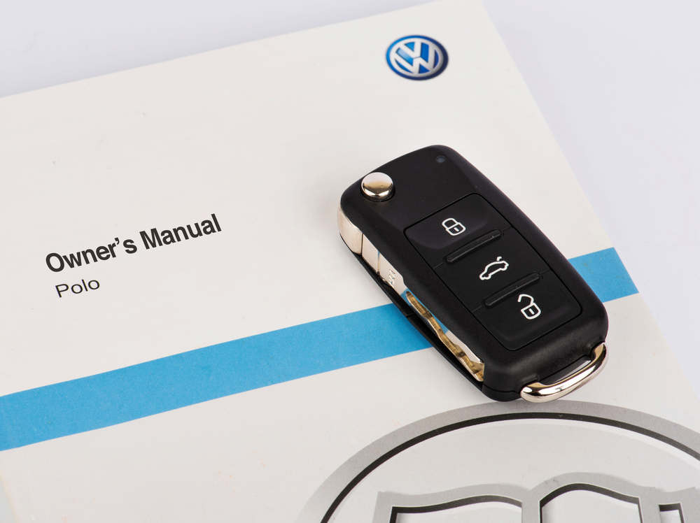 ISTANBUL, TURKEY - JANUARY 27, 2021: Volkswagen Owners Manual Guide Book and key.
