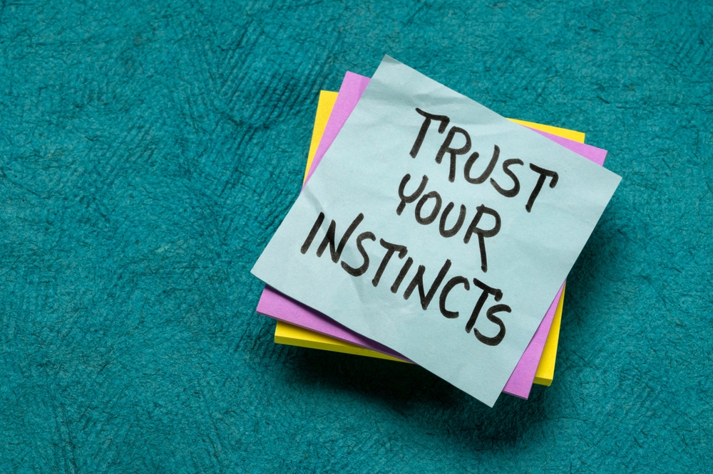 trust your instincts - advice or motivational reminder on a sticky note, confidence and personal development concept
