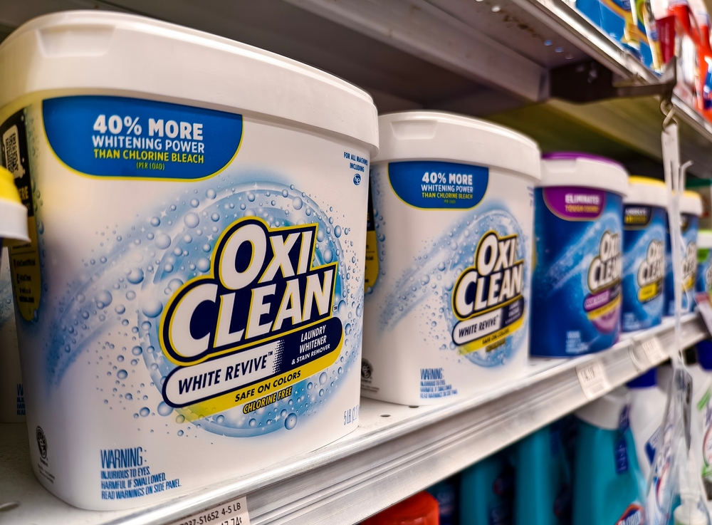 Florida, USA - July 7, 2024: OxiClean containers on a supermarket shelf showcasing laundry detergent options. Bright, clean packaging emphasizes stain removal and whitening power.