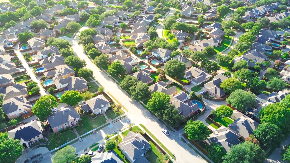 Peaceful residential street in Riverbend North neighborhood row of upscale suburban houses with swimming pools in West Plano, urban sprawl suburbs Dallas Fort Worth metroplex, Texas, aerial view. USA
