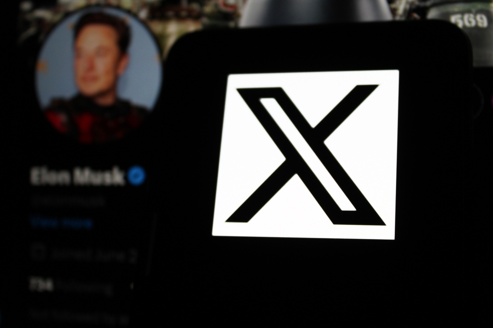 The X logo is displayed on a smartphone screen. With Elon Musk's X account profile photo in the background. Indonesia - September 1, 2024