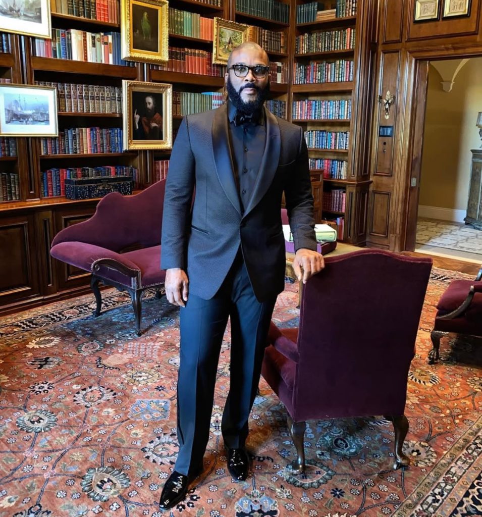 Tyler Perry standing in library