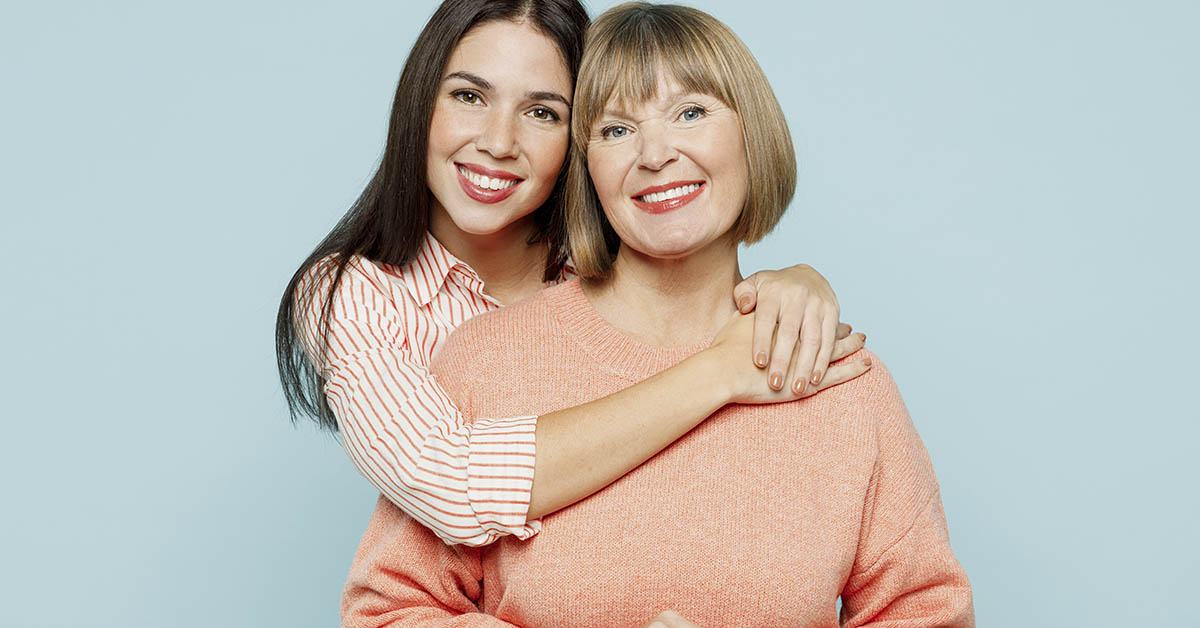Mother and daughter posing together embracing