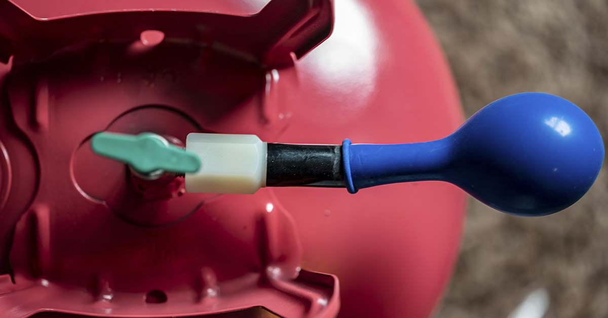 Ballon being blown up using helium tank