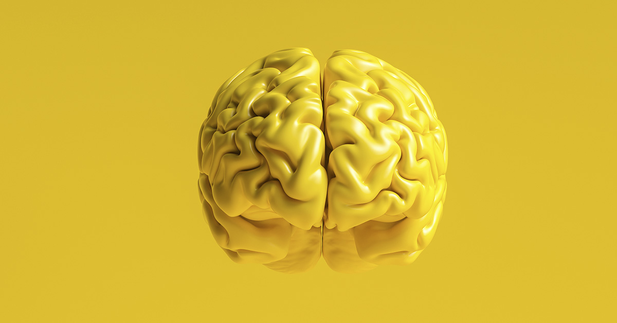 3D rendering of a yellow colored brain, yellow background
