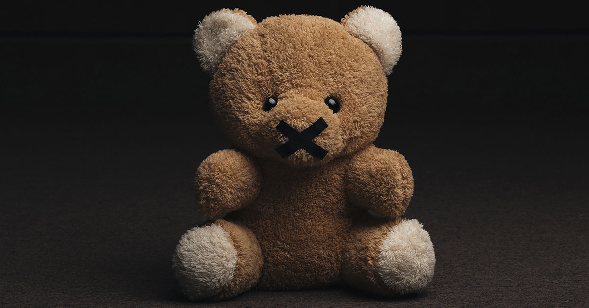 Teddy Bear with X over mouth.