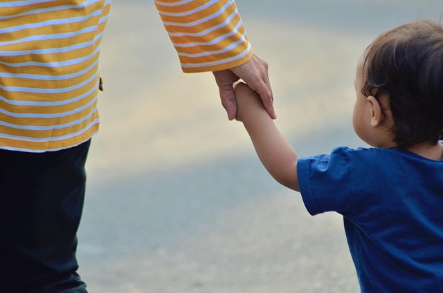 mom and child walking hand in hand