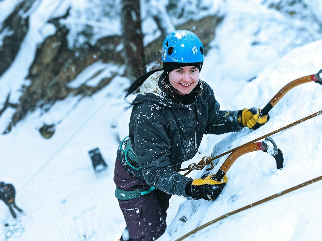 Girl Climbing Snowy Mountain Using Snow Hooks