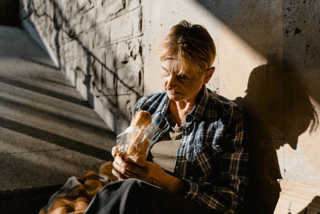 Woman Holding Bread sitting on ramp