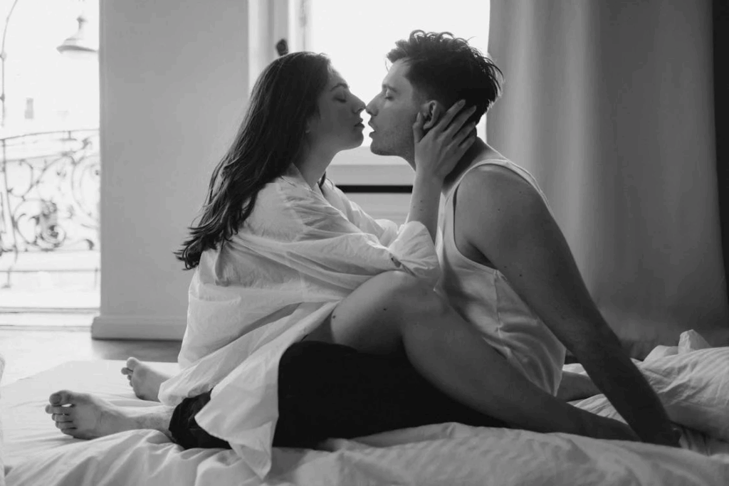 A Romantic Couple Kissing on a bed