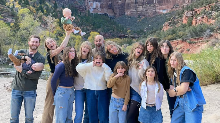 Angela Goodrich and her husband Matt Goodrich posing with their children outdoors against dramatic red rock canyon backdrop, showing the family supporting each other through difficult times.