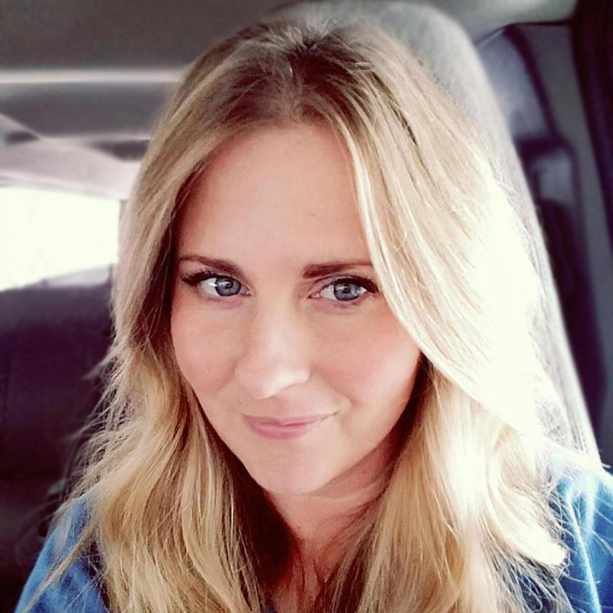 Angela Goodrich with blonde hair taking a selfie in a car, smiling gently at the camera, representing life before diagnosis.