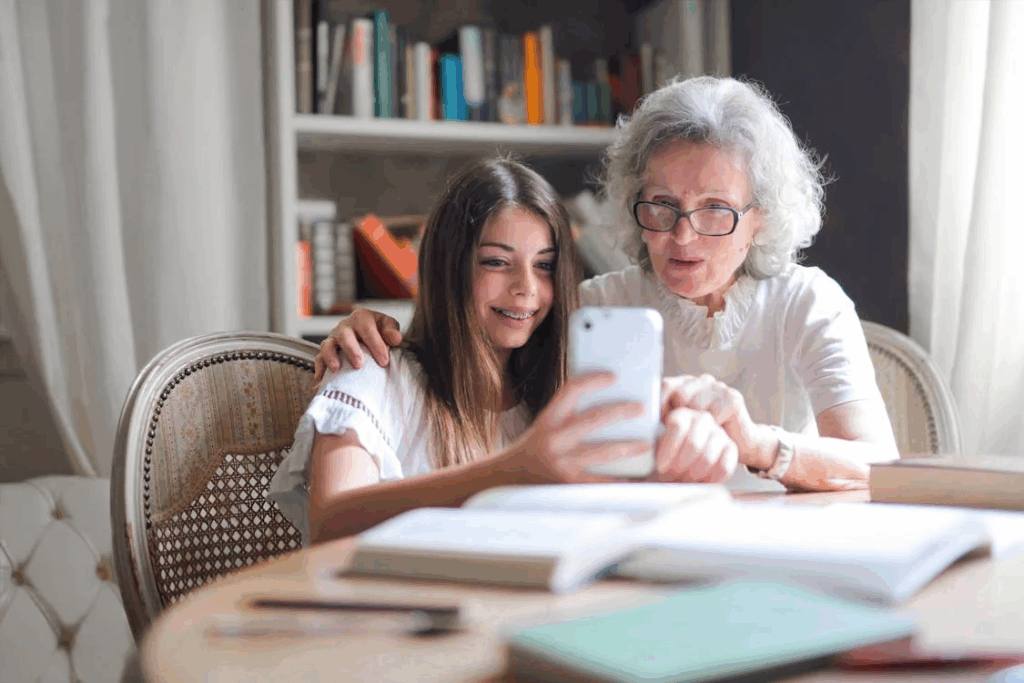 Photo of Girl Showing Her Cellphone to Her Grandmother