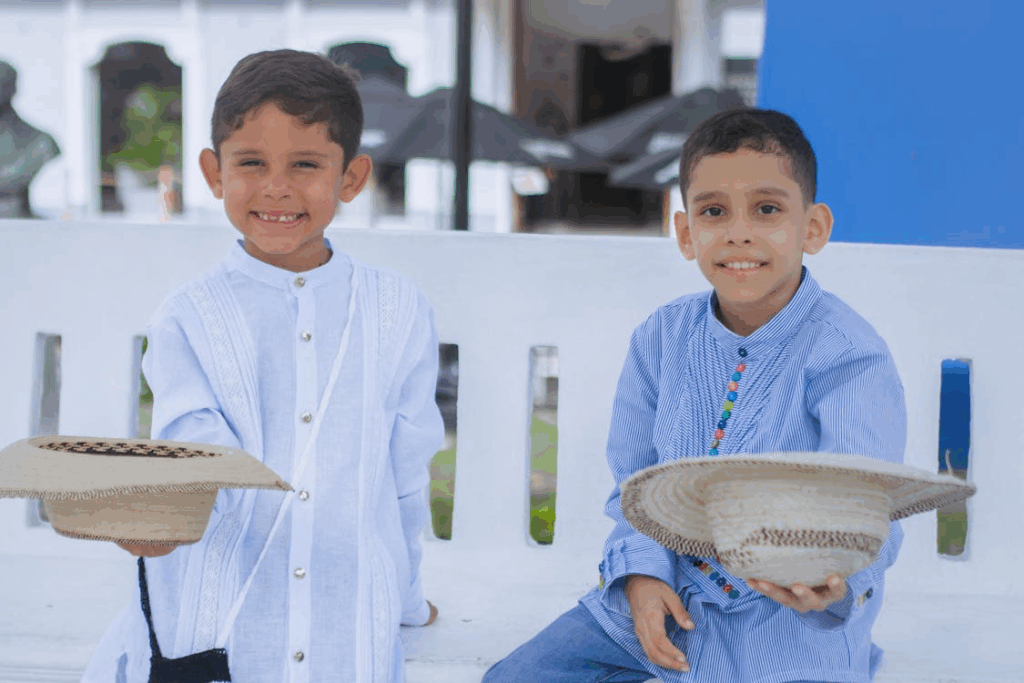 Two Happy Boys Holding Hats
