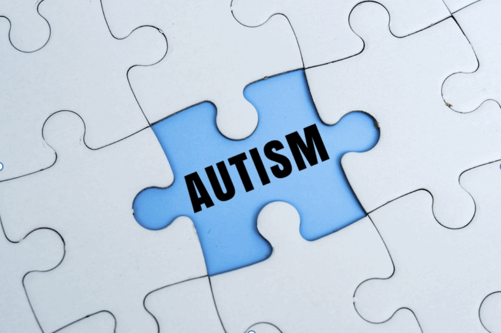 AUTISM word alphabet letters on puzzle as a background