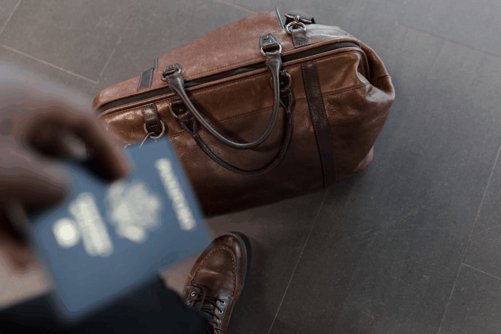Brown Leather Duffel Bag and passport
