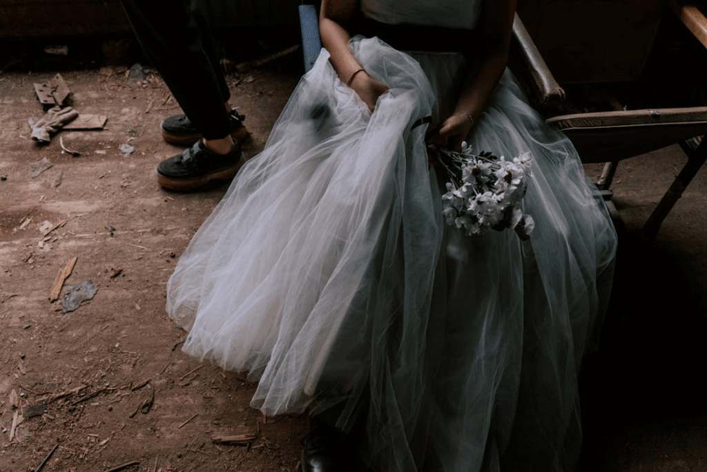 Woman in White Wedding Gown Holding Bouquet of White Flowers