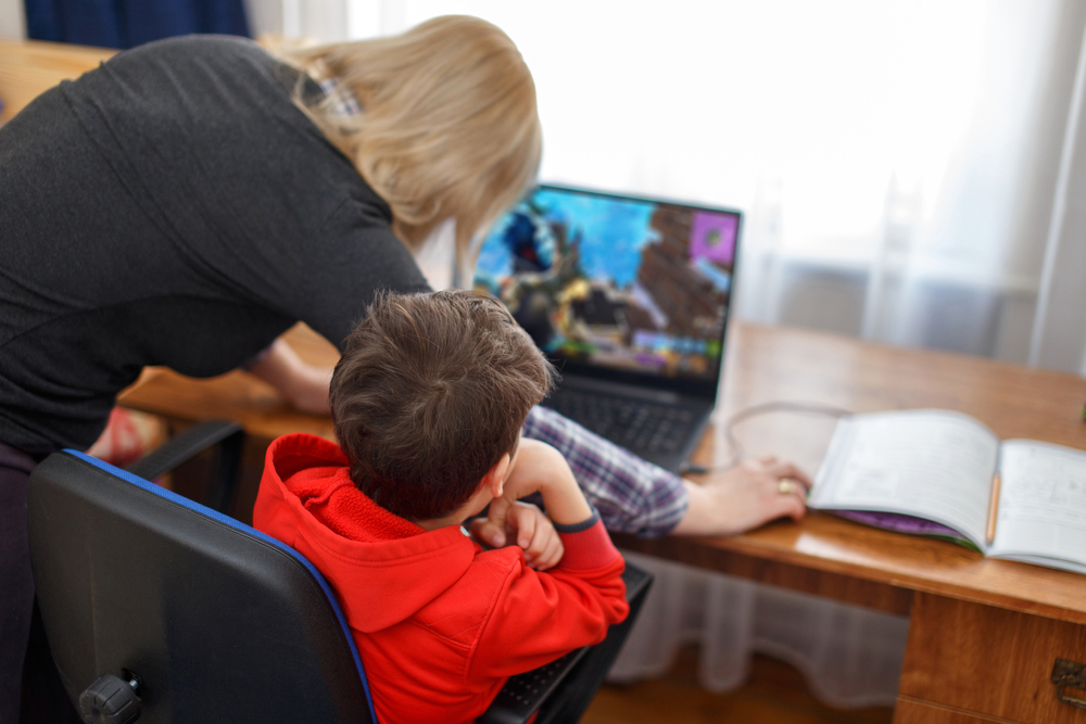 mother turning off child's computer in the middle of a game
